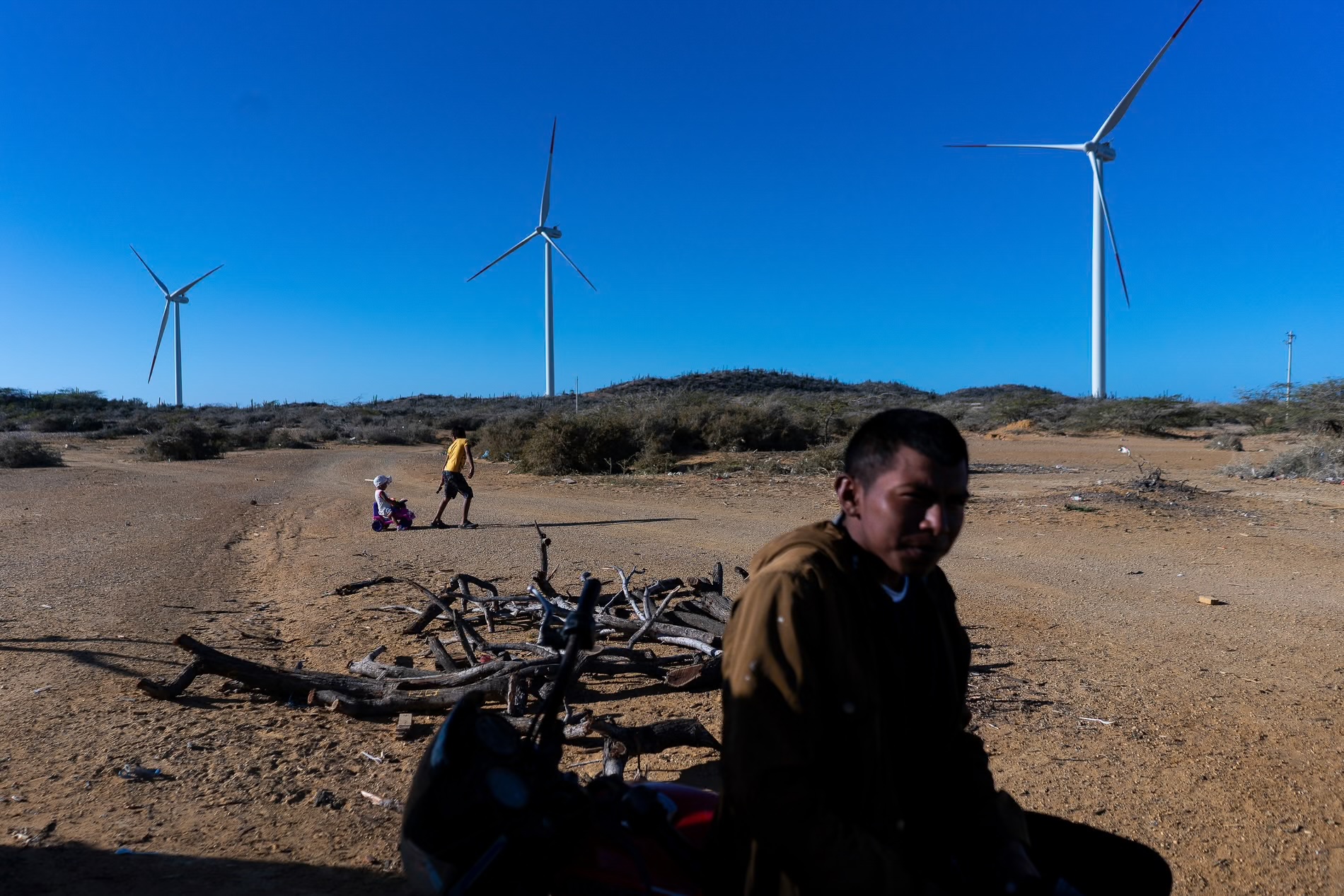 boy with wind turbines in the background