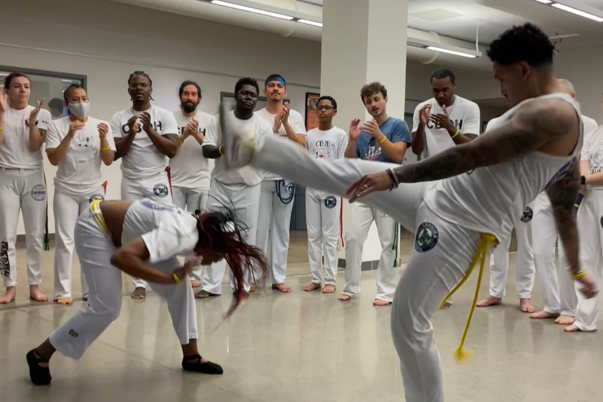 two people playing capoeira