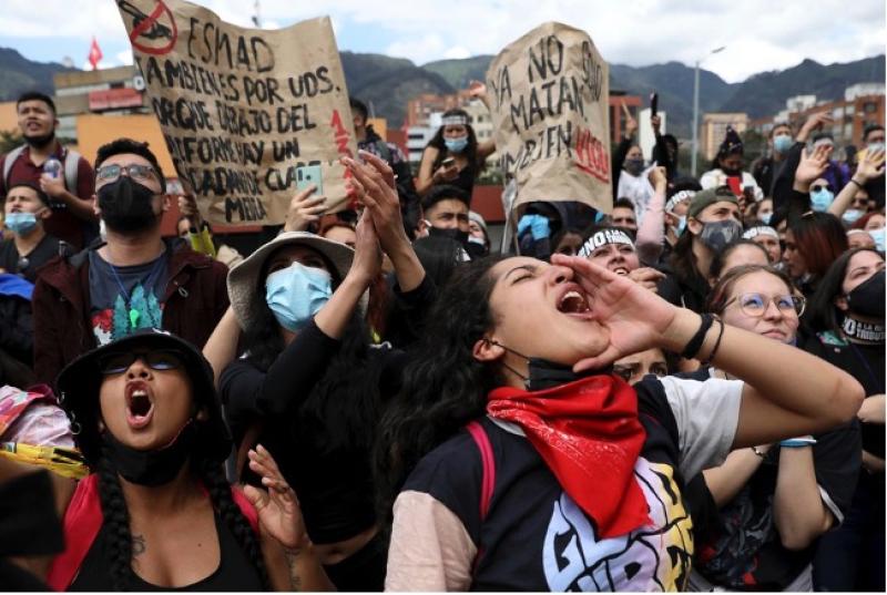 People shout slogans during a demonstration against government-proposed tax reform, marking May Day, or International Workers' Day, in Bogota, Colombia, on May 1, 2021. Fernando Vergara / AP