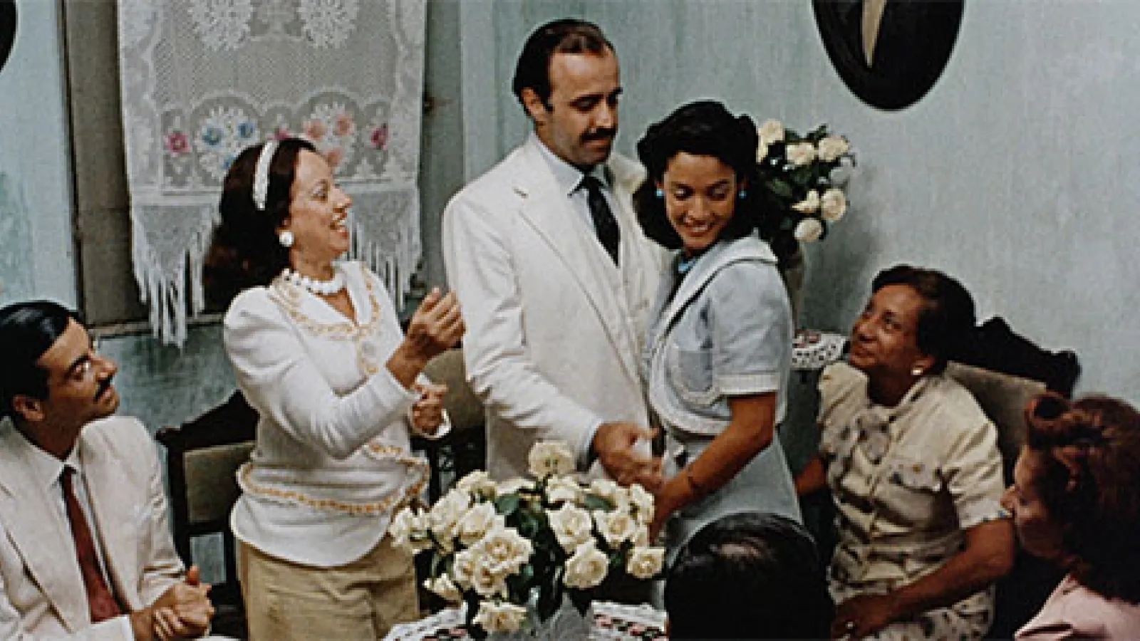 characters in a living room, woman hugging man