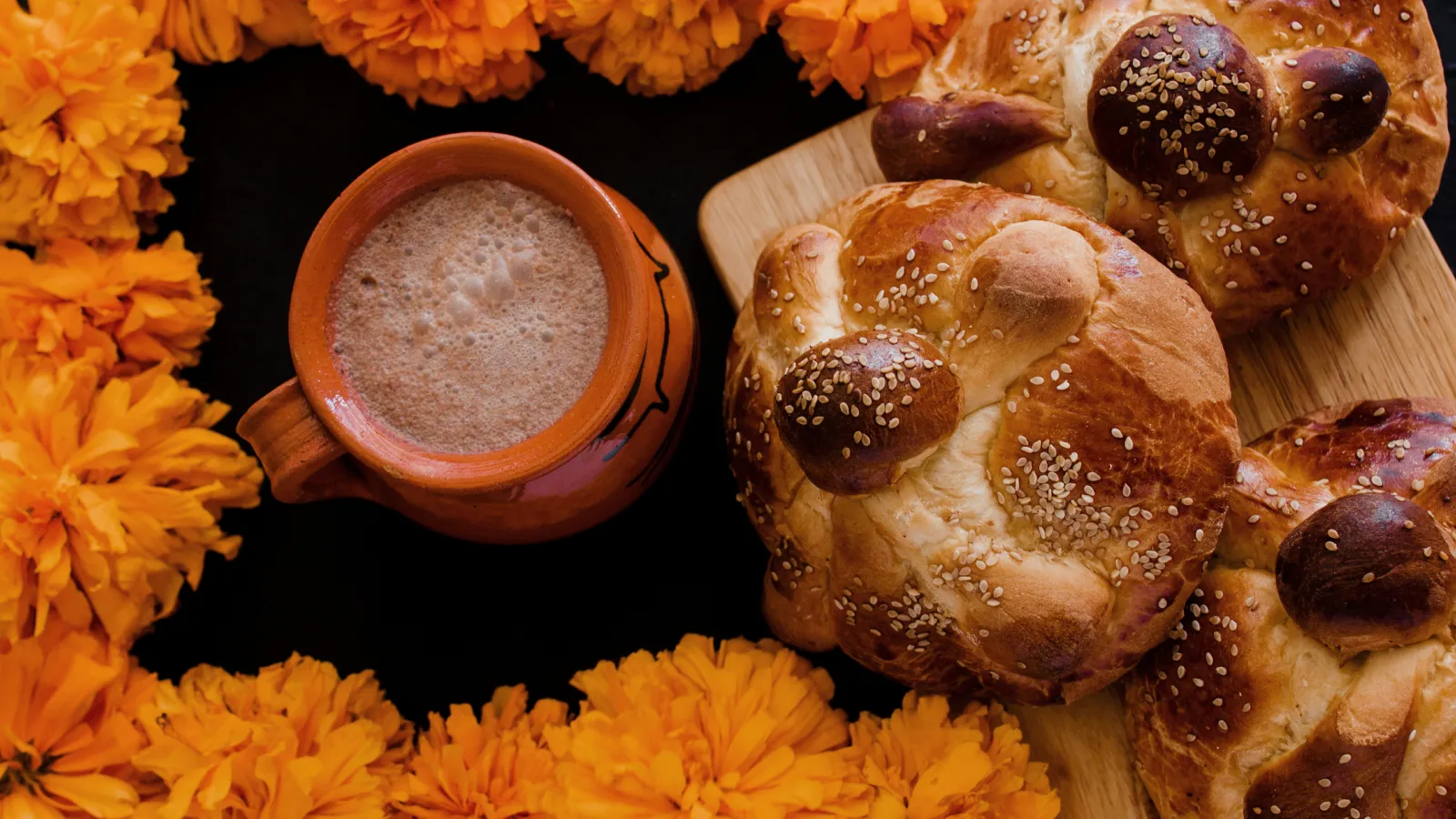 Pan de muerto, hot cocoa, marigolds