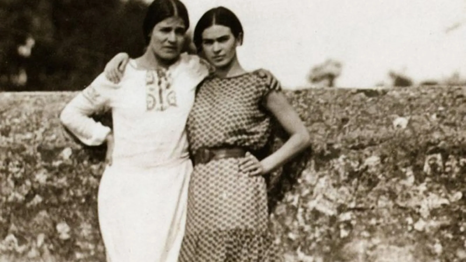 two women (Tima Modotti and Frida Kahlo) standing, black and white