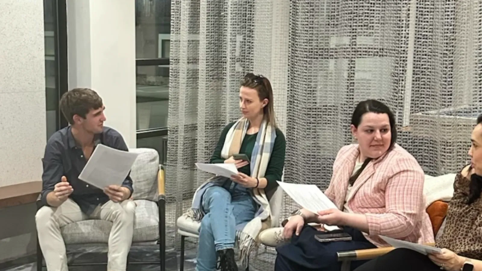 man and two women sitting on a couch talking