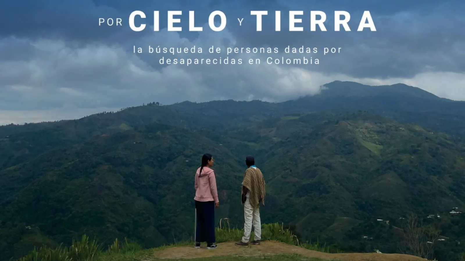 two people in front of mountains