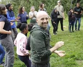 Daniel Bryan clapping in a circle with more people