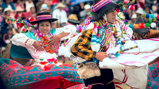 man and woman in indigenous clothing dancing
