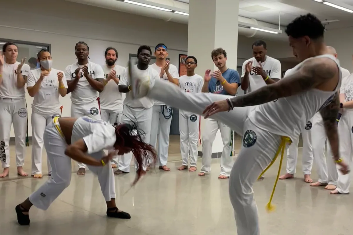 two people playing capoeira