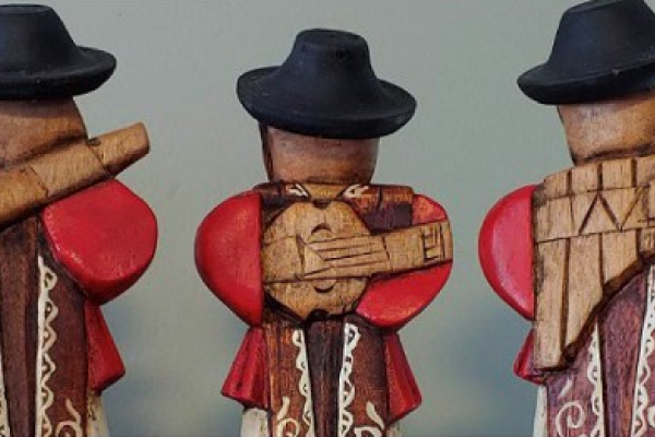 A figurine of three persons playing Andean musical instruments