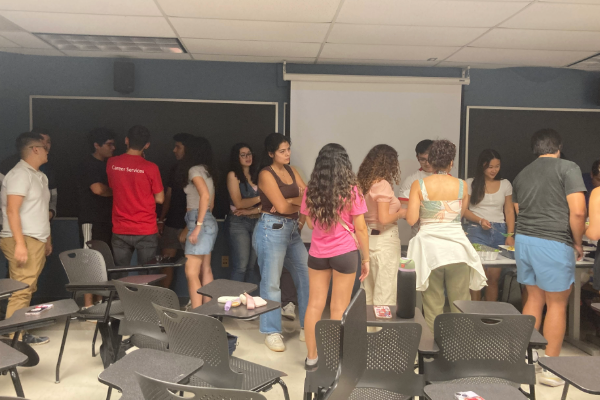 Students in classroom lining up for food.