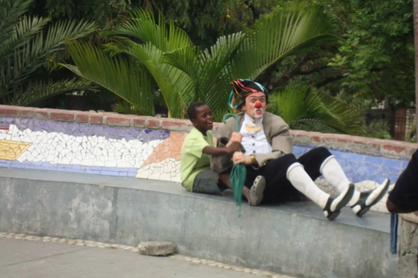 boy and clown pretending to be on a boat