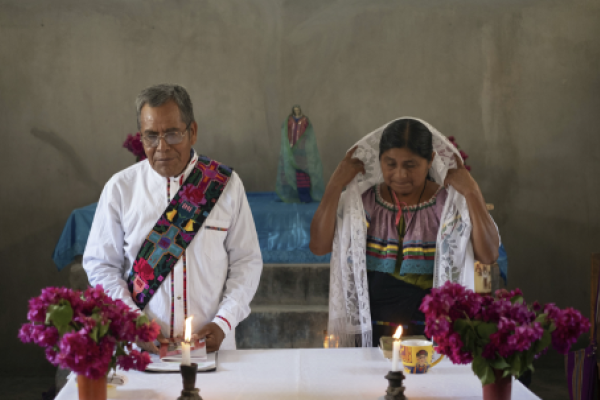 Deacon Juan Pérez Gómez, accompanied by his wife Crecencia López, stands at the altar during a Mass honouring the late Pope Francis, in Simojovel, Mexico