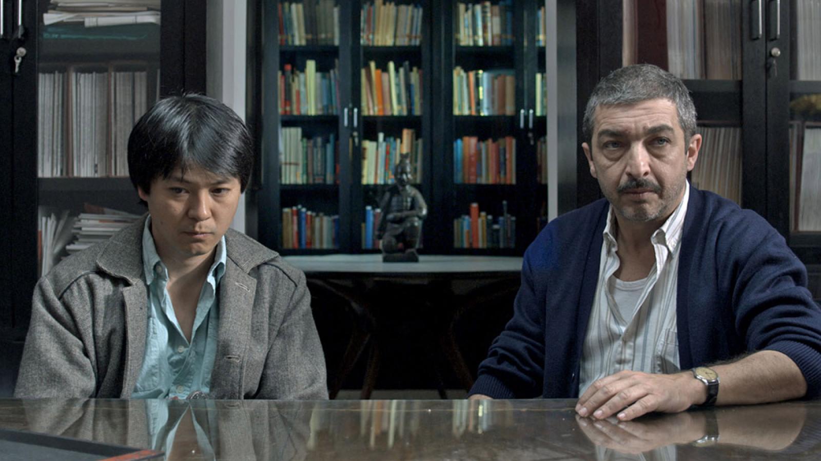 two men sitting at a table