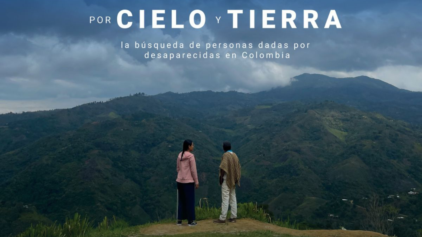 two people in front of mountains