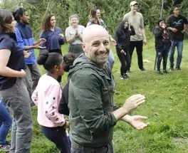 Daniel Bryan clapping in a circle with more people